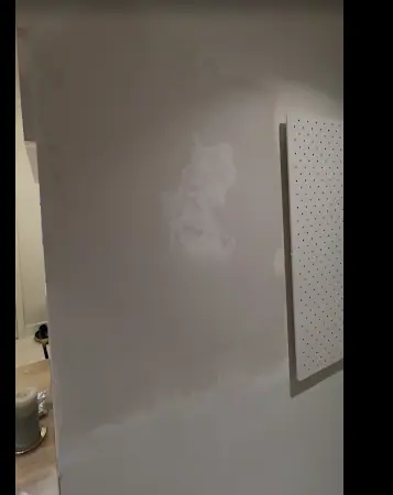 Completed: The wall with both holes patched and smoothed