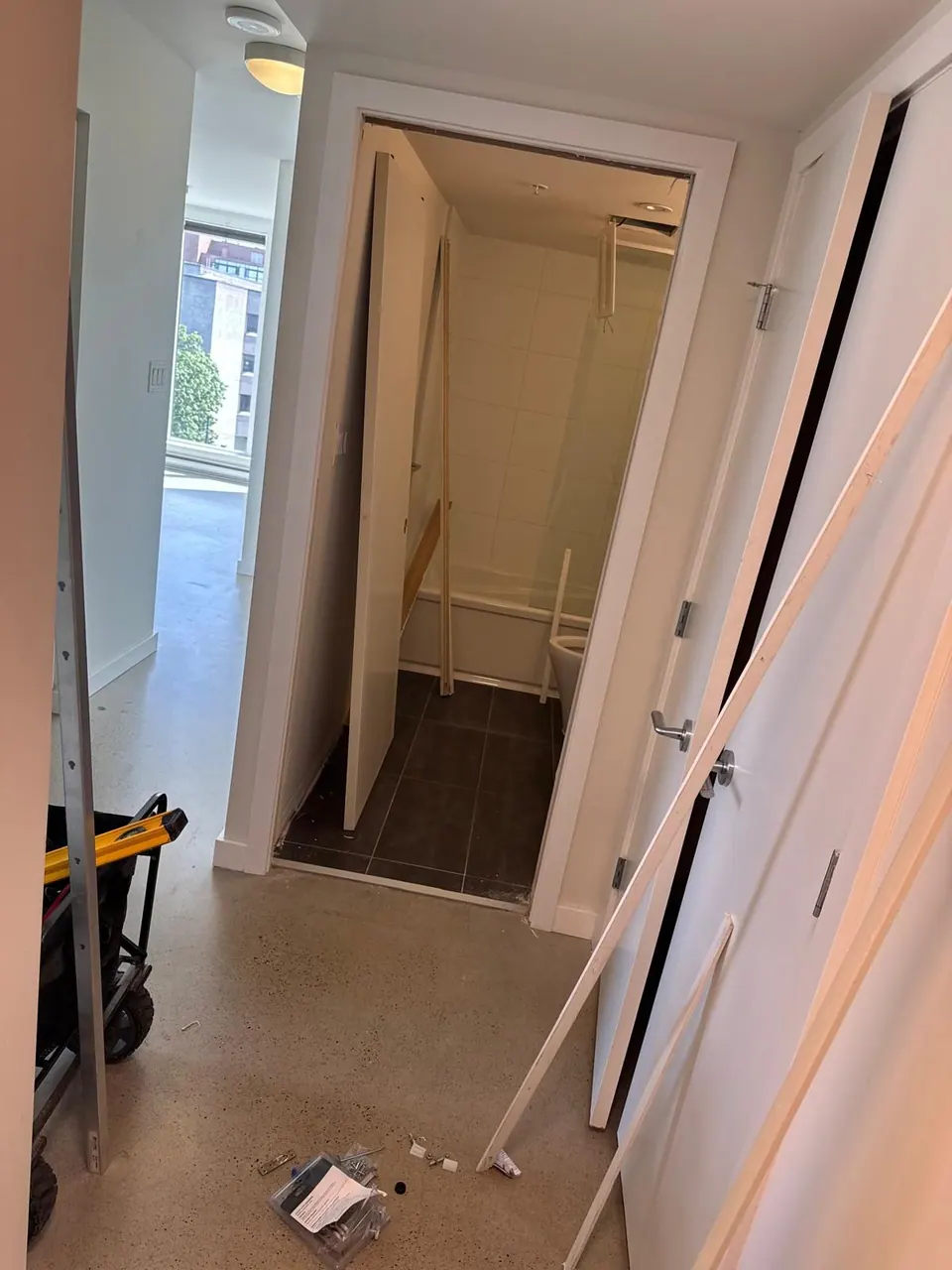 Earlier: Pocket door opening with the door out of its track and tools on the floor