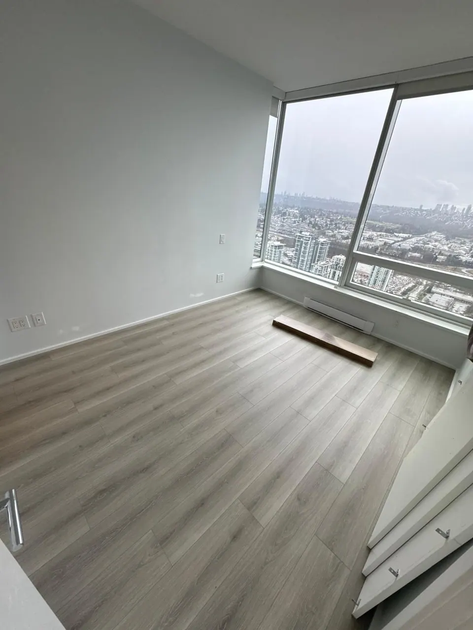 Completed: Finished plank floor and baseboard in the same corner room