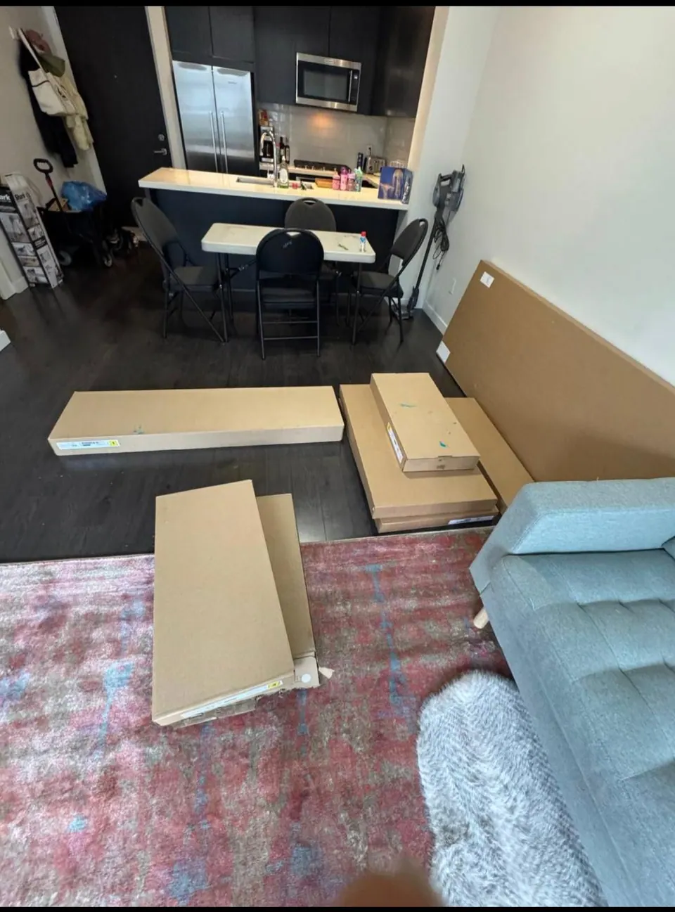 Earlier: Flat-pack boards and boxes laid out on the living room floor before assembly