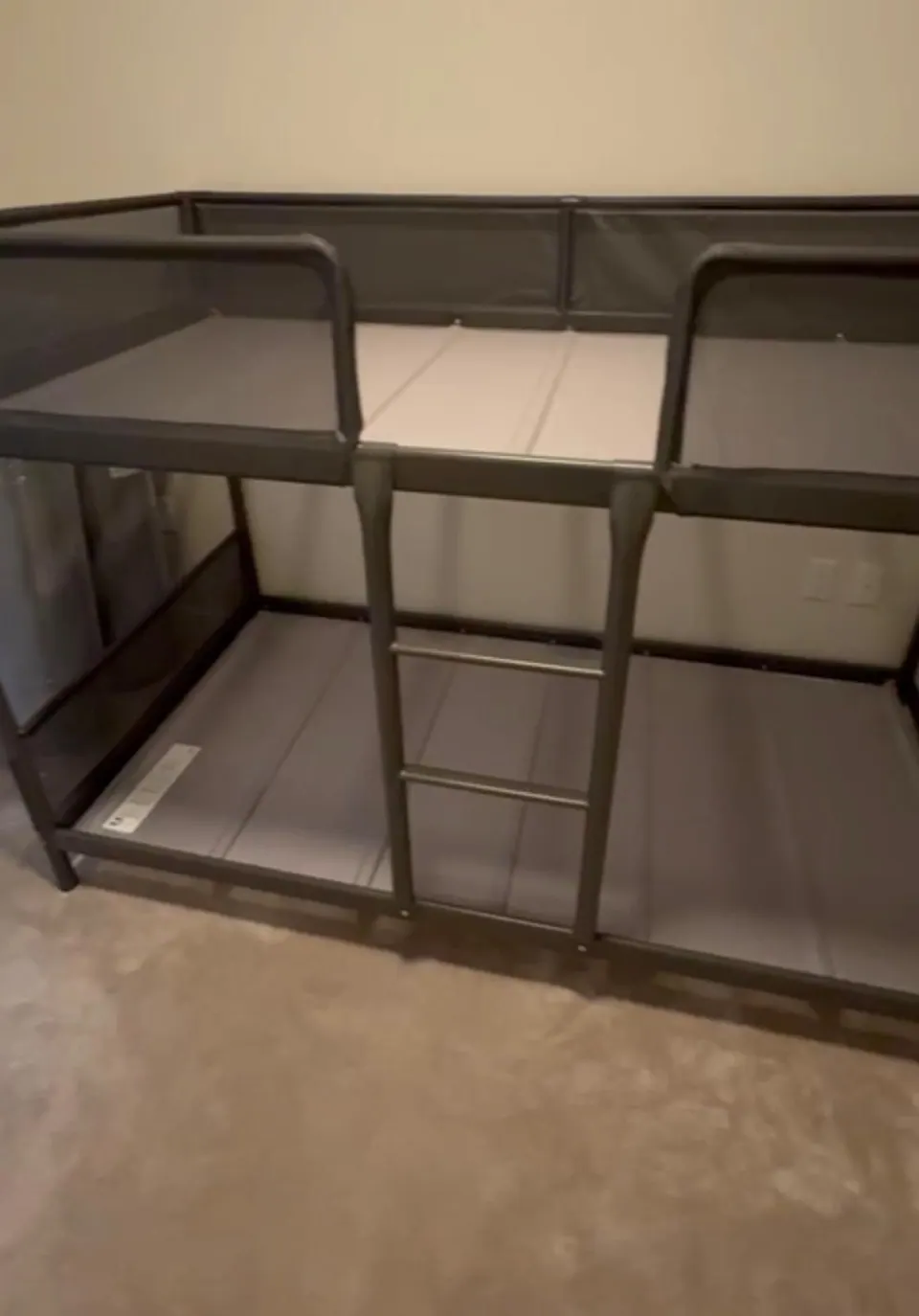 Completed: Assembled metal bunk bed frame with ladder and safety rails