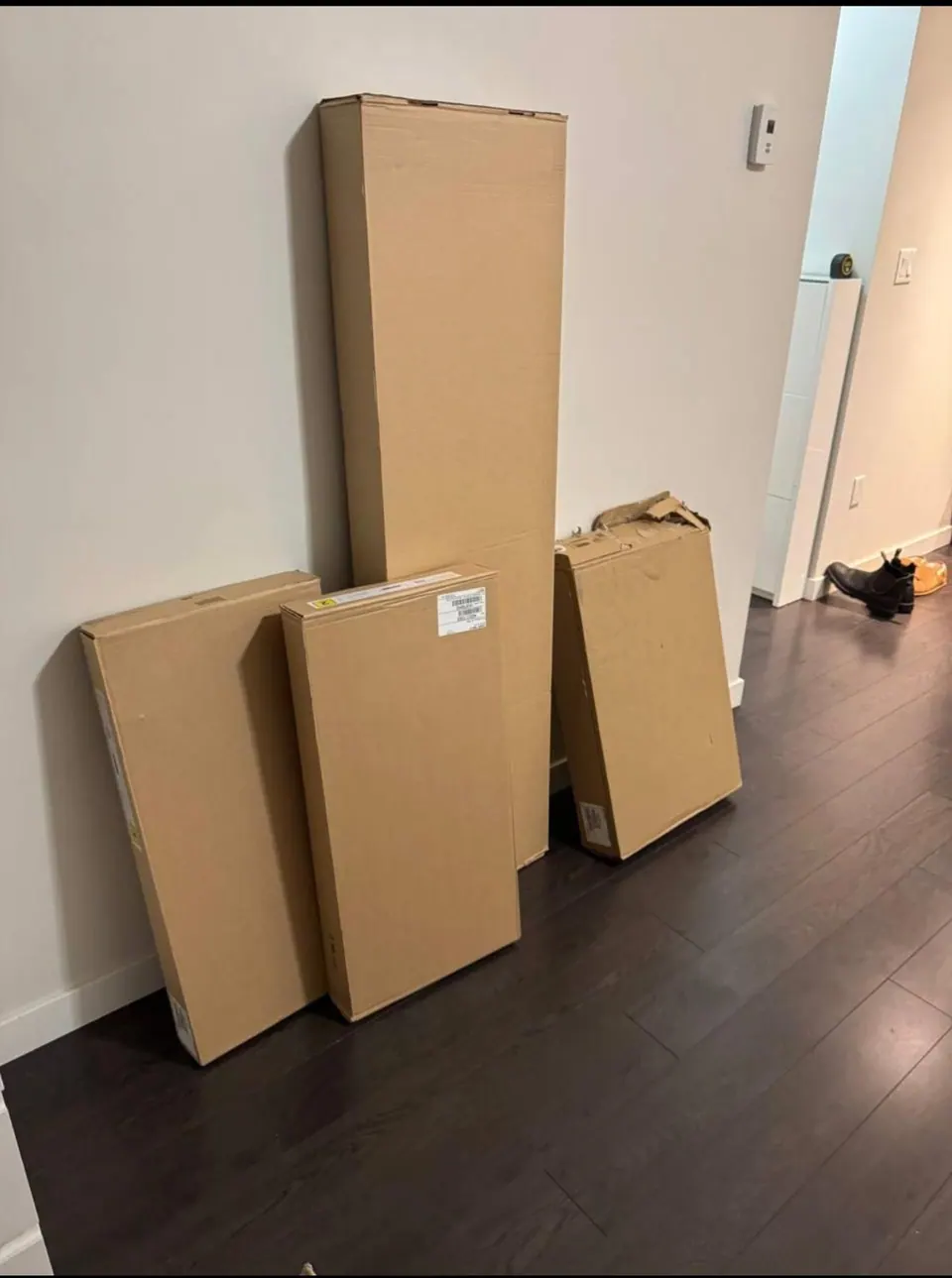 Earlier: Flat-pack bunk bed boxes stacked in a hallway before assembly